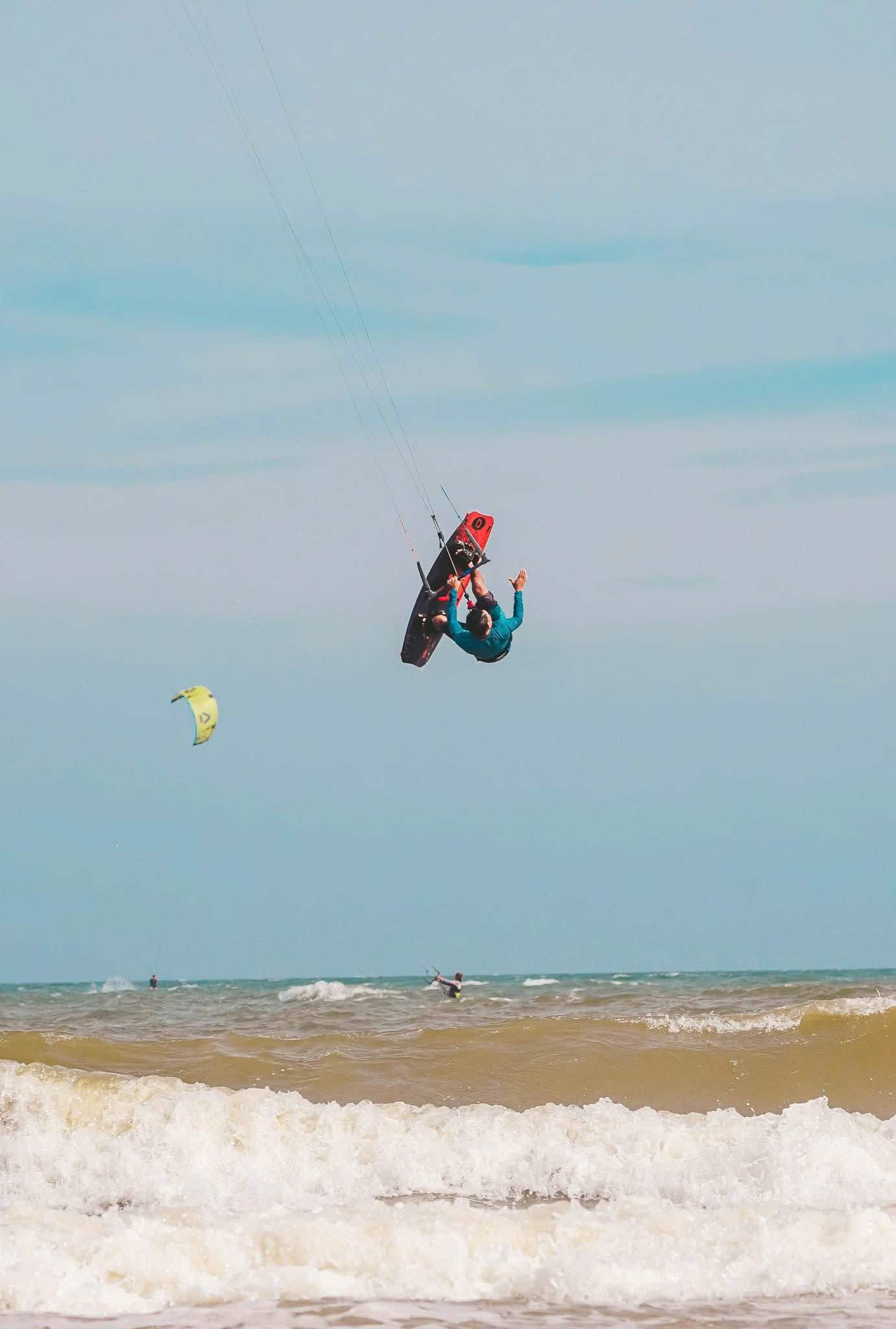 Kiteboarder jumping above the sea