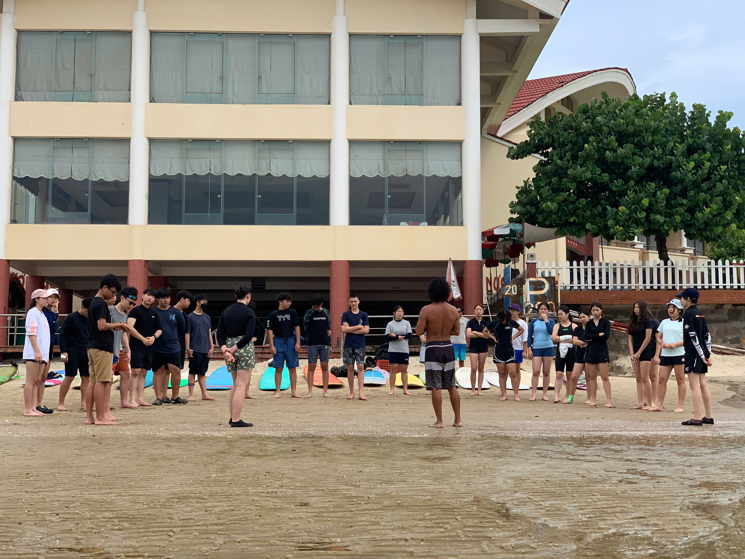 Kiteboarding students standing together on the beach